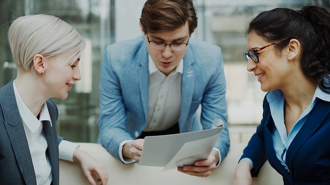 Professional team coordinating billing calendars in an office setting
